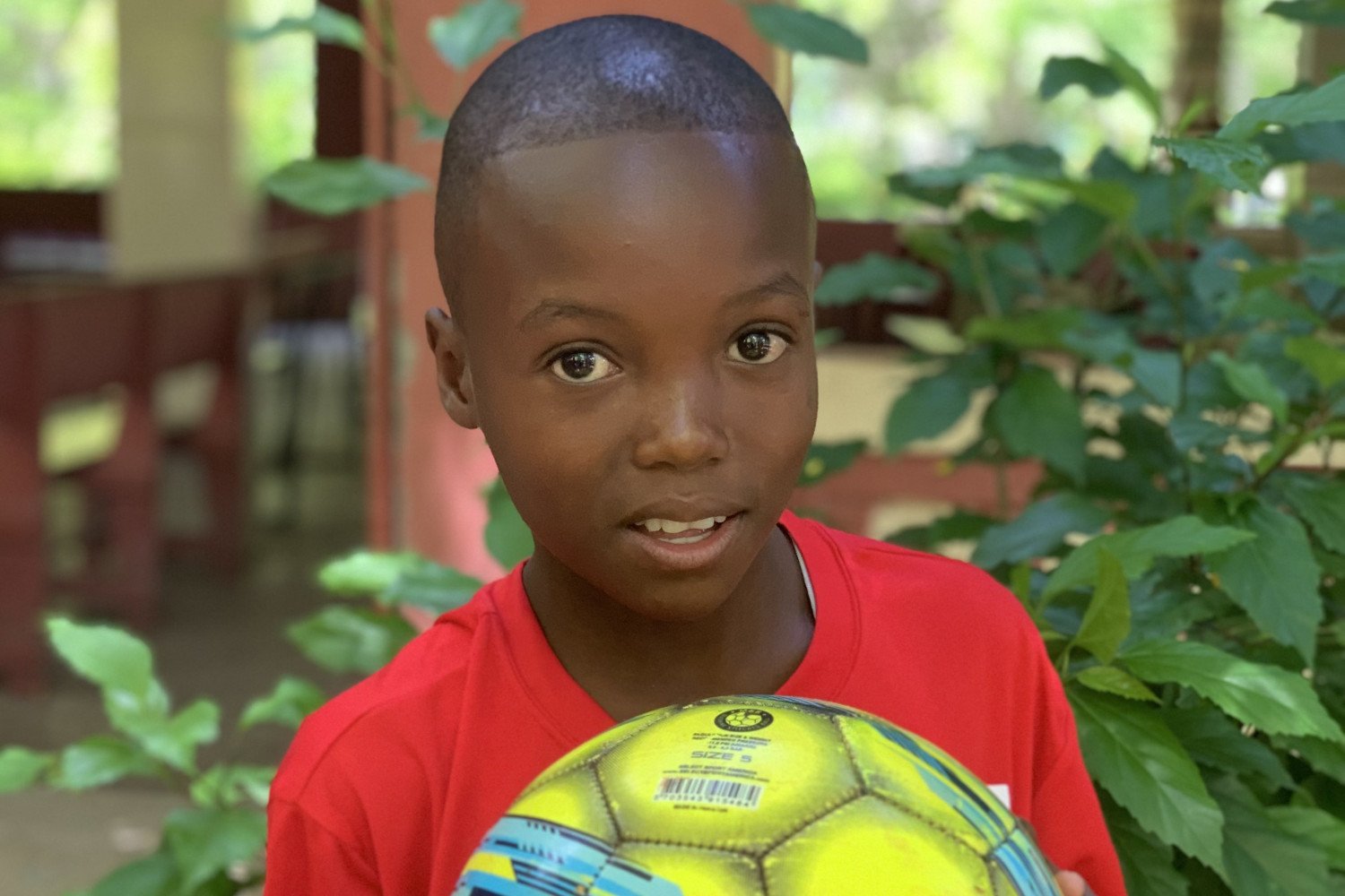 Haitian boy holding a soccer ball