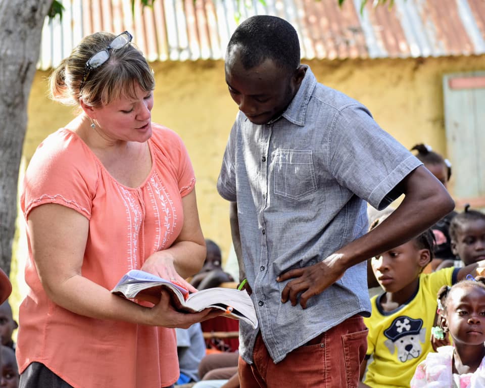 woman and man looking at book